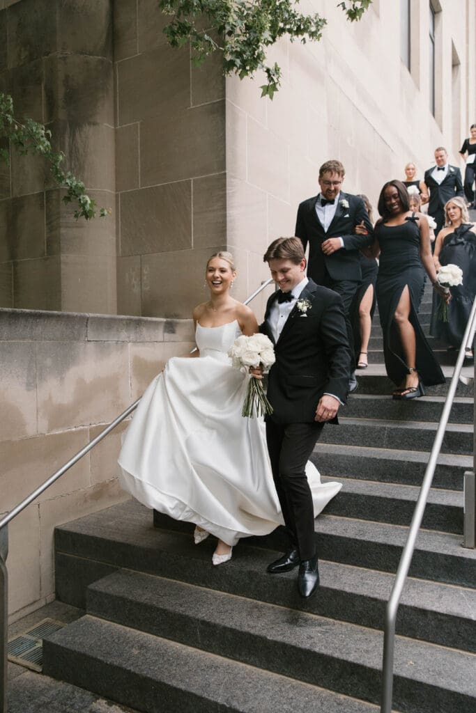 Bride and groom walking hand in hand at the Nelson-Atkins Museum of Art in Kansas City