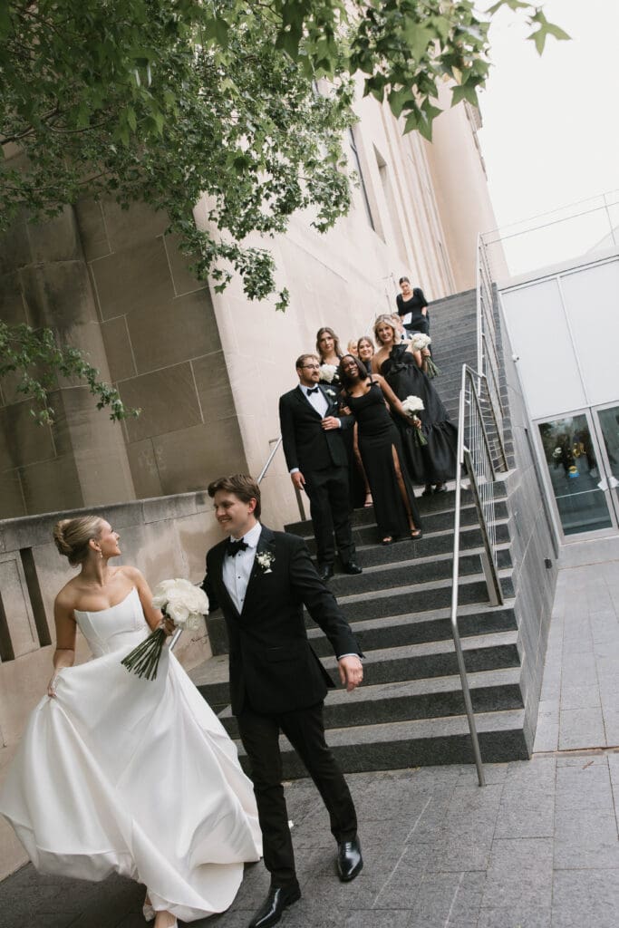 Bride and groom walking hand in hand at the Nelson-Atkins Museum of Art in Kansas City