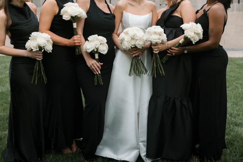 Wedding party bouquets together on the museum lawn.