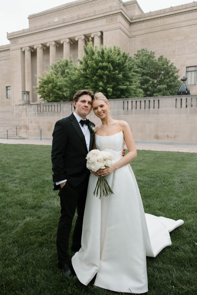 Bride and groom walking hand in hand at the Nelson-Atkins Museum of Art in Kansas City