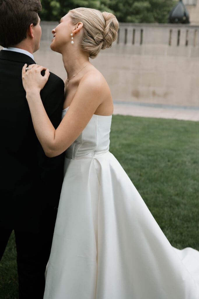 Bride and groom walking hand in hand at the Nelson-Atkins Museum of Art in Kansas City